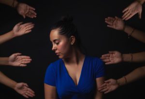 girl turning head, black background, hands reaching out, sad, linh dang hypnocoach, consciousness expert, people-pleaser vs. rejecter, blog about consciousness, fear of rejection, unconscious mechanism, coping mechanism, rtt, rapid transformational therapy